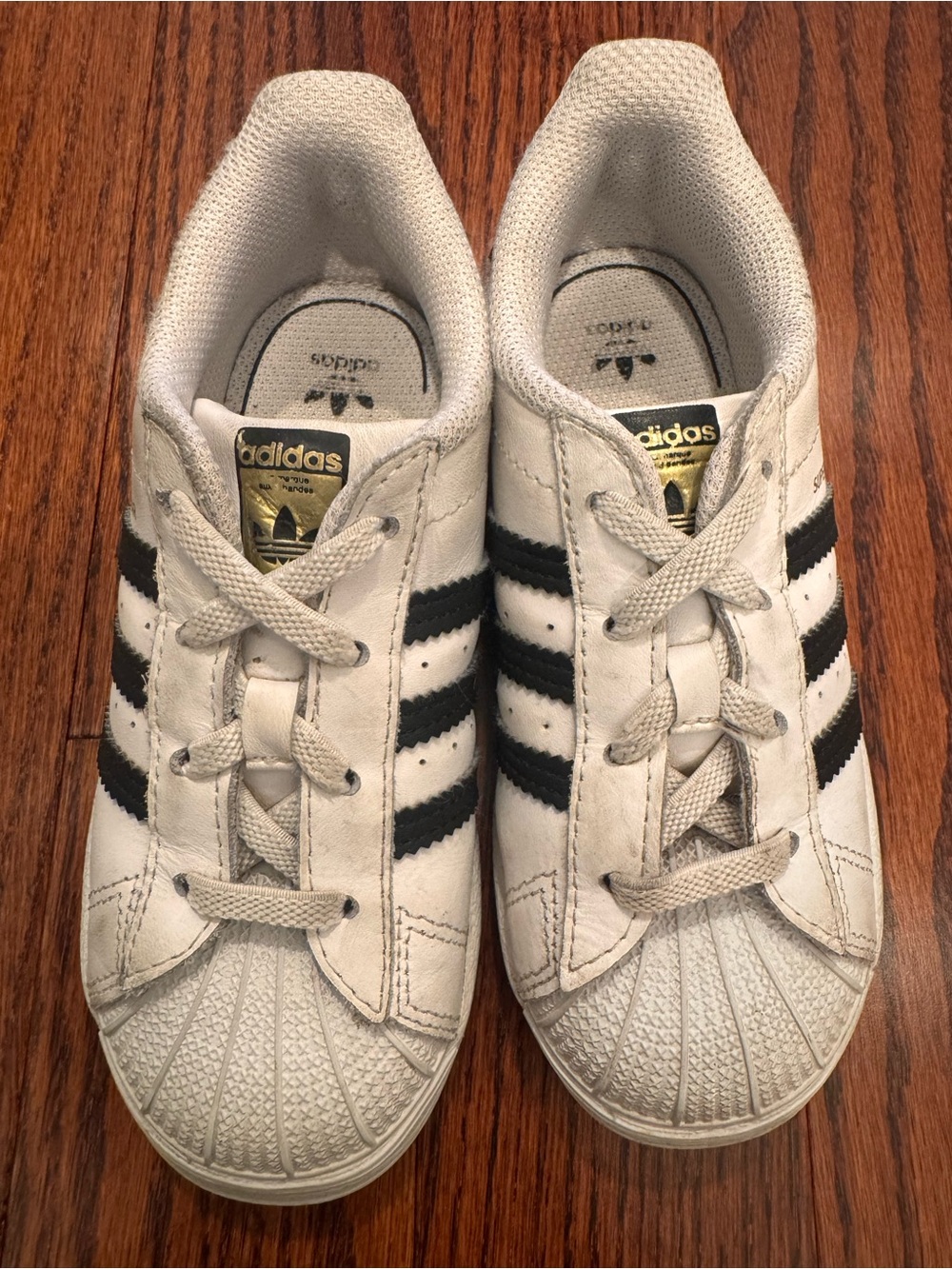 adidas Kids White Sneakers with Black Stripes and Gold Tongue Logo